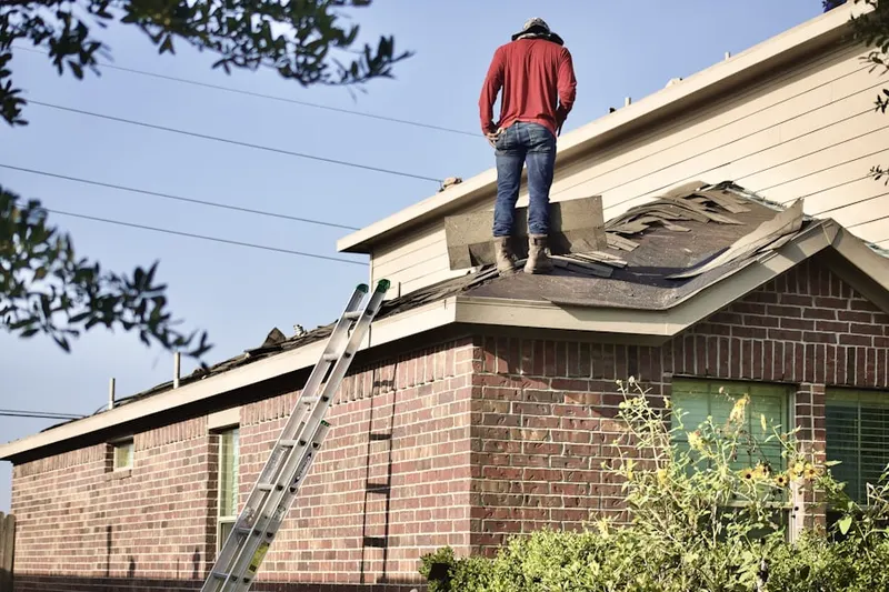 Professional roofer working on a residential roof in Sparrows Point
